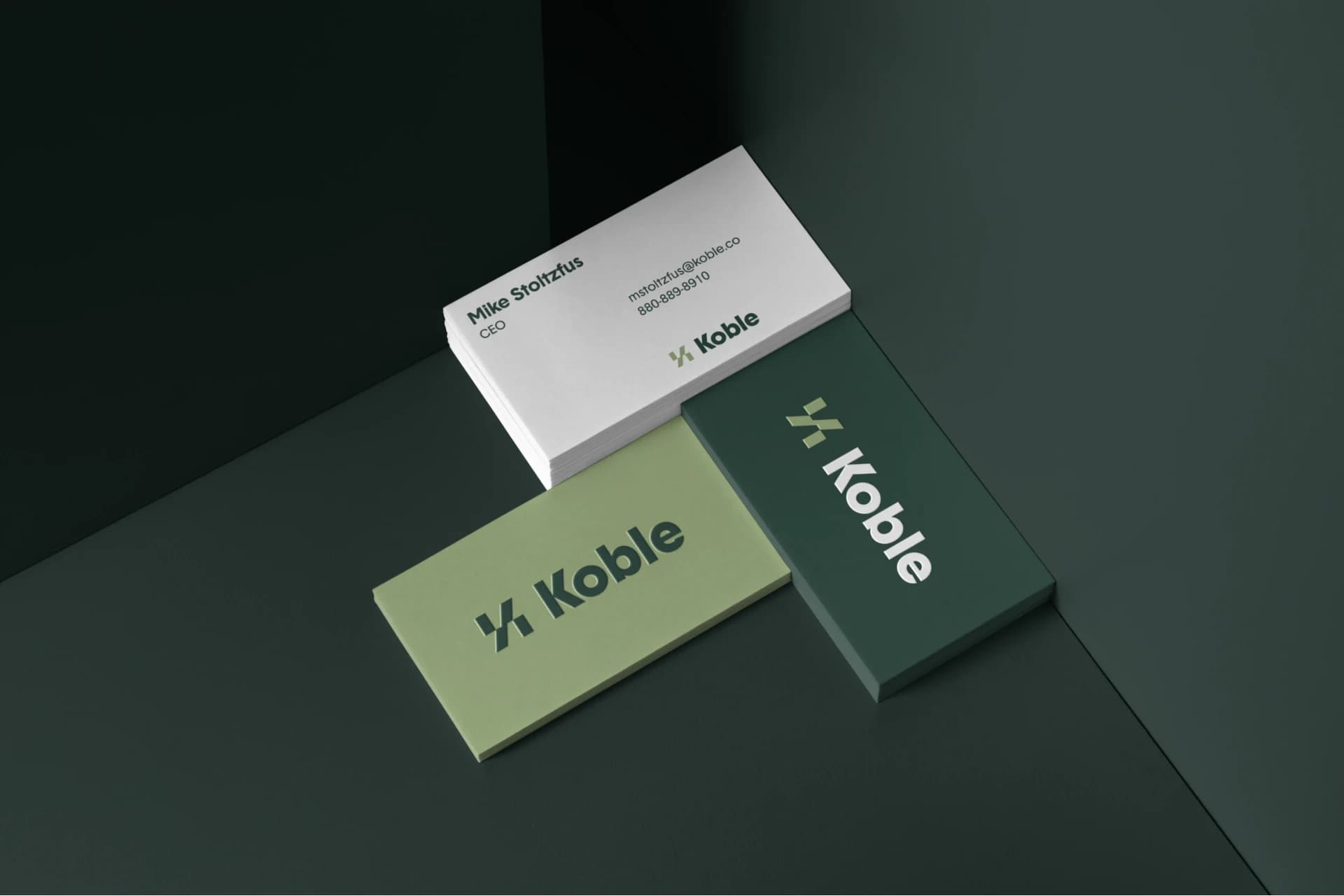 Koble business cards in forest green, olive, and white.
