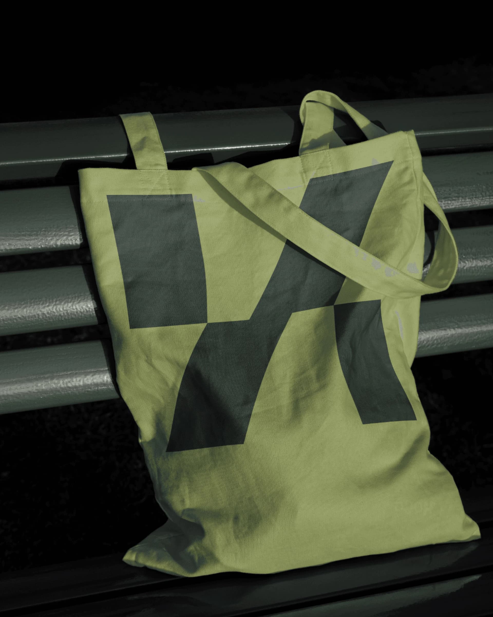 Pale green tote bag with an oversized Koble symbol.
