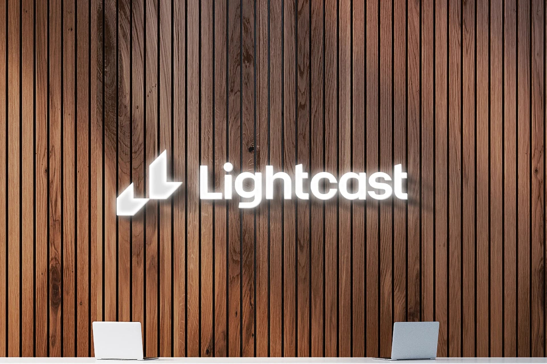 Lightcast’s white wordmark and symbol displayed on an office wall.